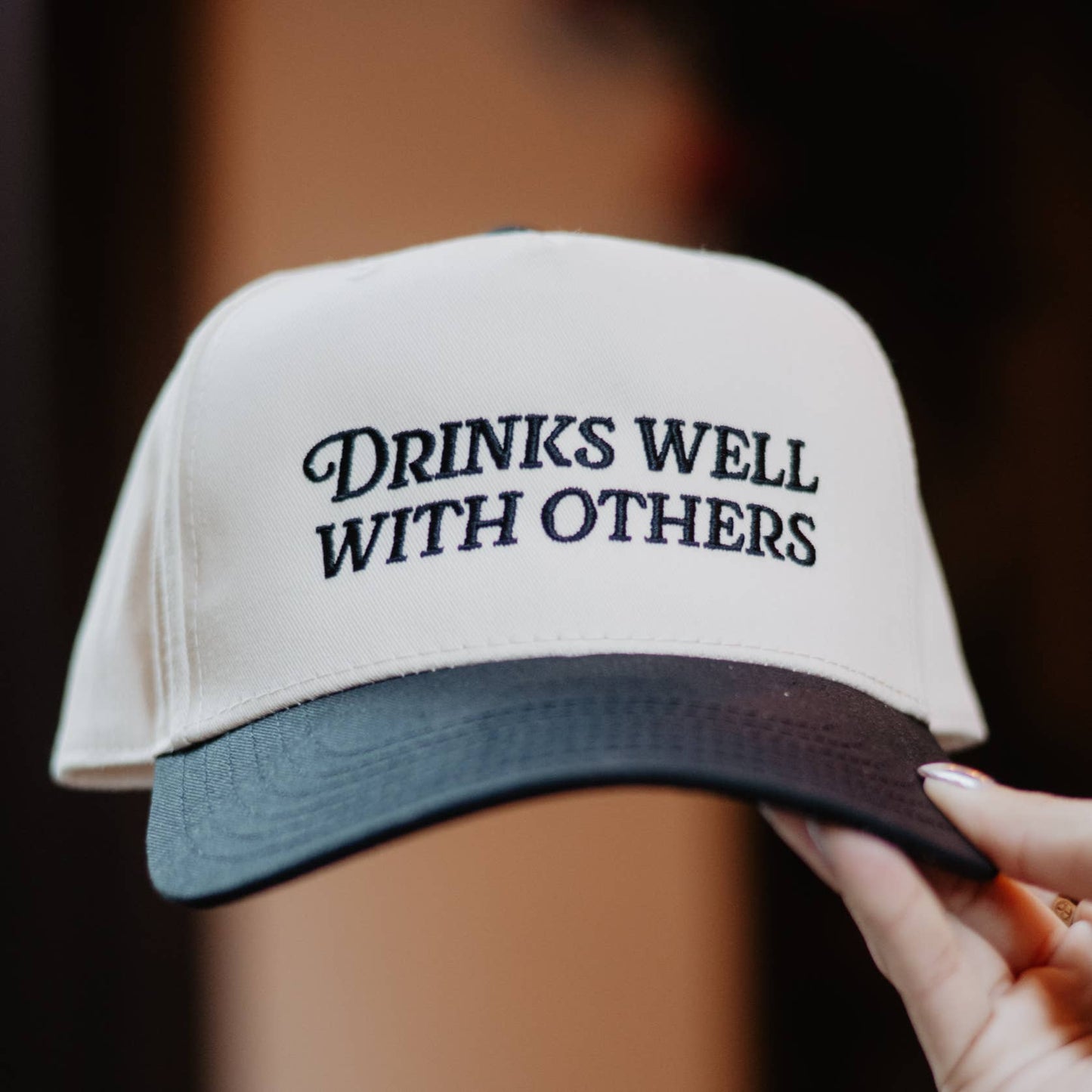 Drinks Well With Others Vintage Trucker Hat in Black and Tan