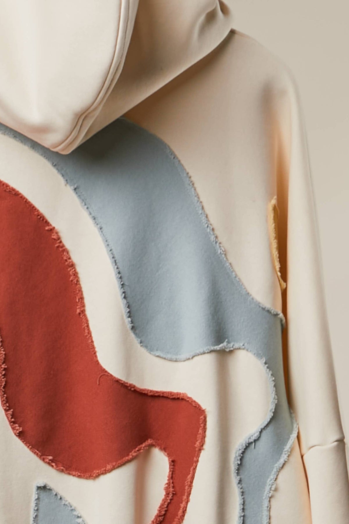 Alissa Abstract Patch Hoodie with Kangaroo Pocket in Cream